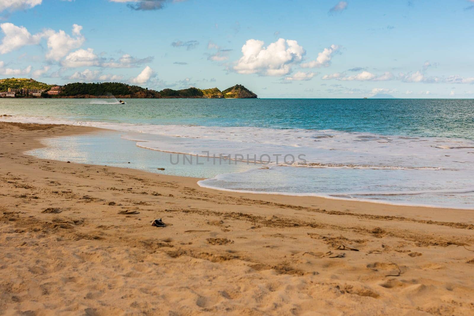 Caribbean beach with white sand, deep blue sky and turquoise water