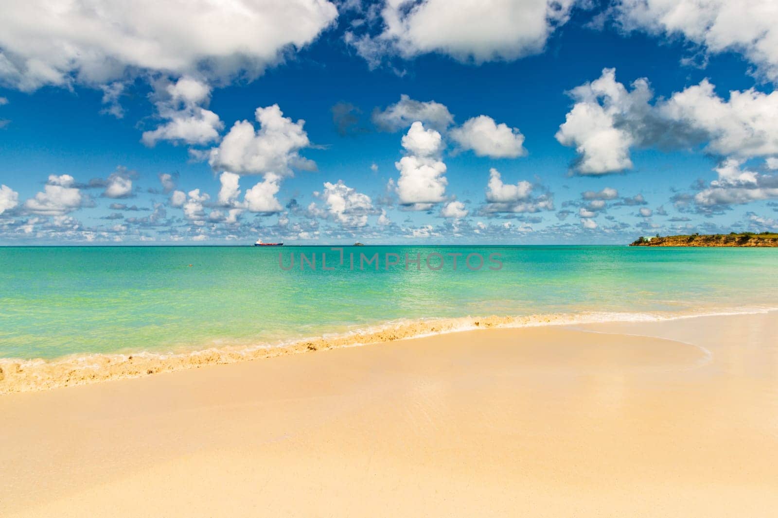 Caribbean beach with white sand, deep blue sky and turquoise water