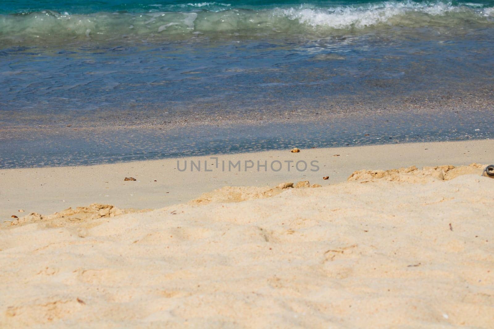 Caribbean beach with white sand, deep blue sky and turquoise water