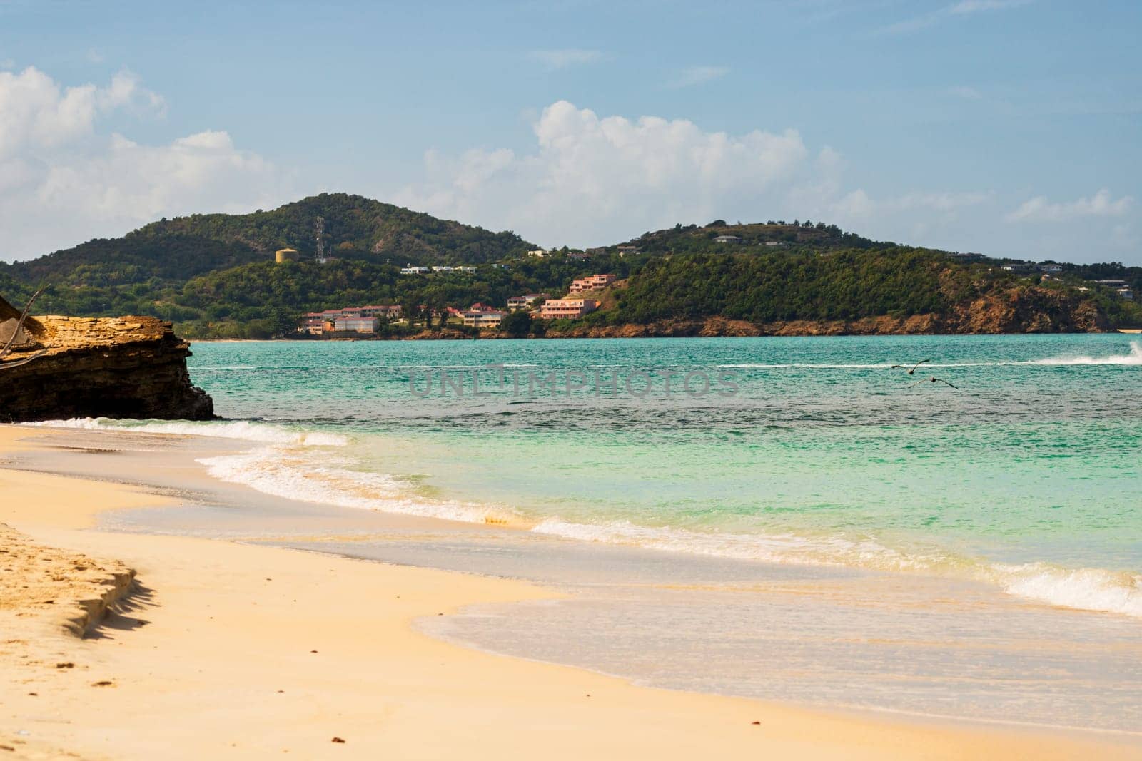 Caribbean beach with white sand, deep blue sky and turquoise water