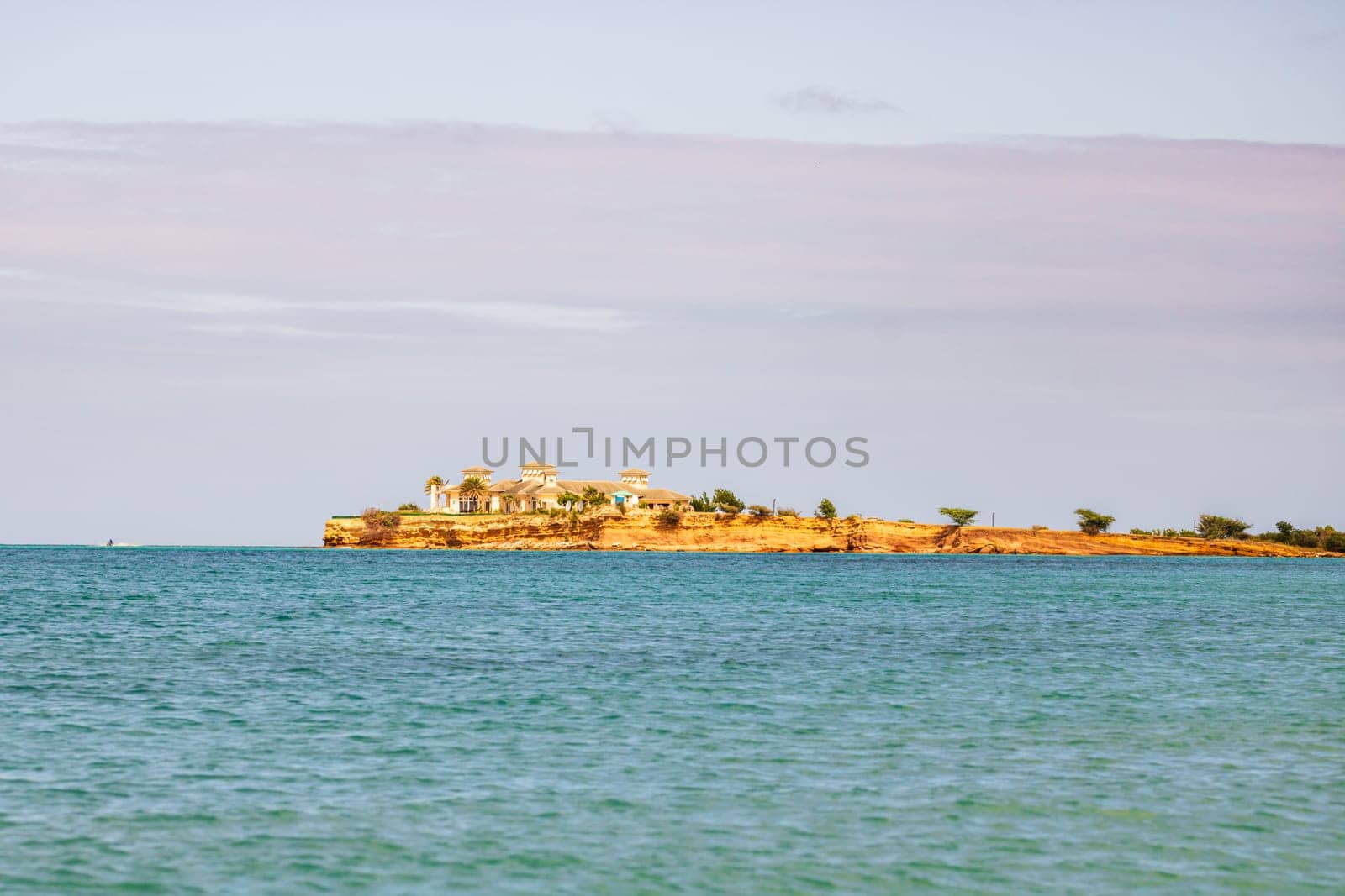 Caribbean beach with white sand, deep blue sky and turquoise water