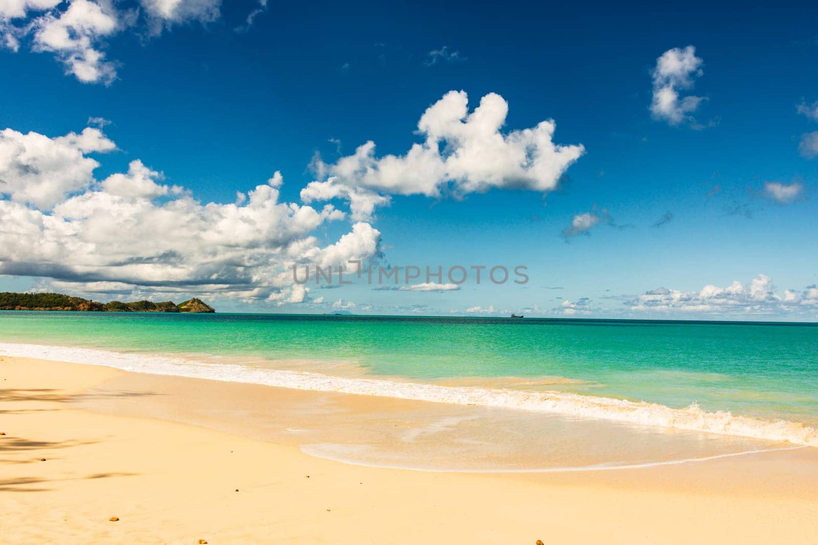 Caribbean beach with white sand, deep blue sky and turquoise water