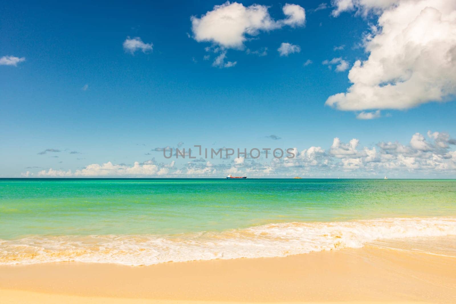 Caribbean beach with white sand, deep blue sky and turquoise water