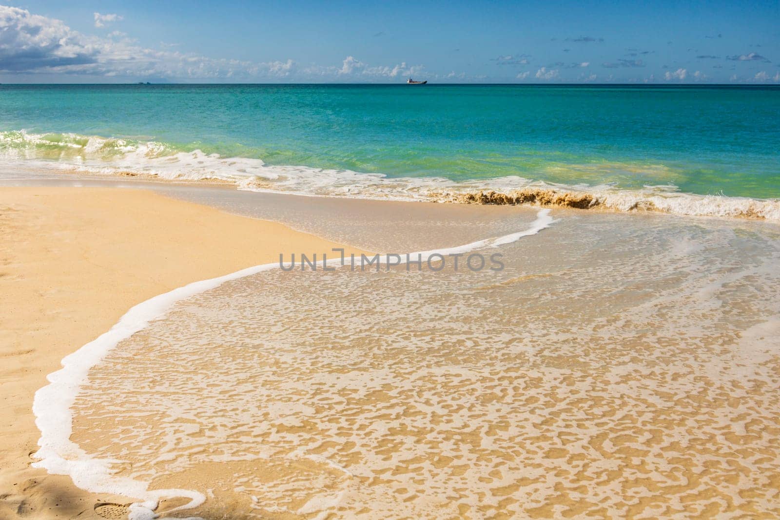 Caribbean beach with white sand, deep blue sky and turquoise water