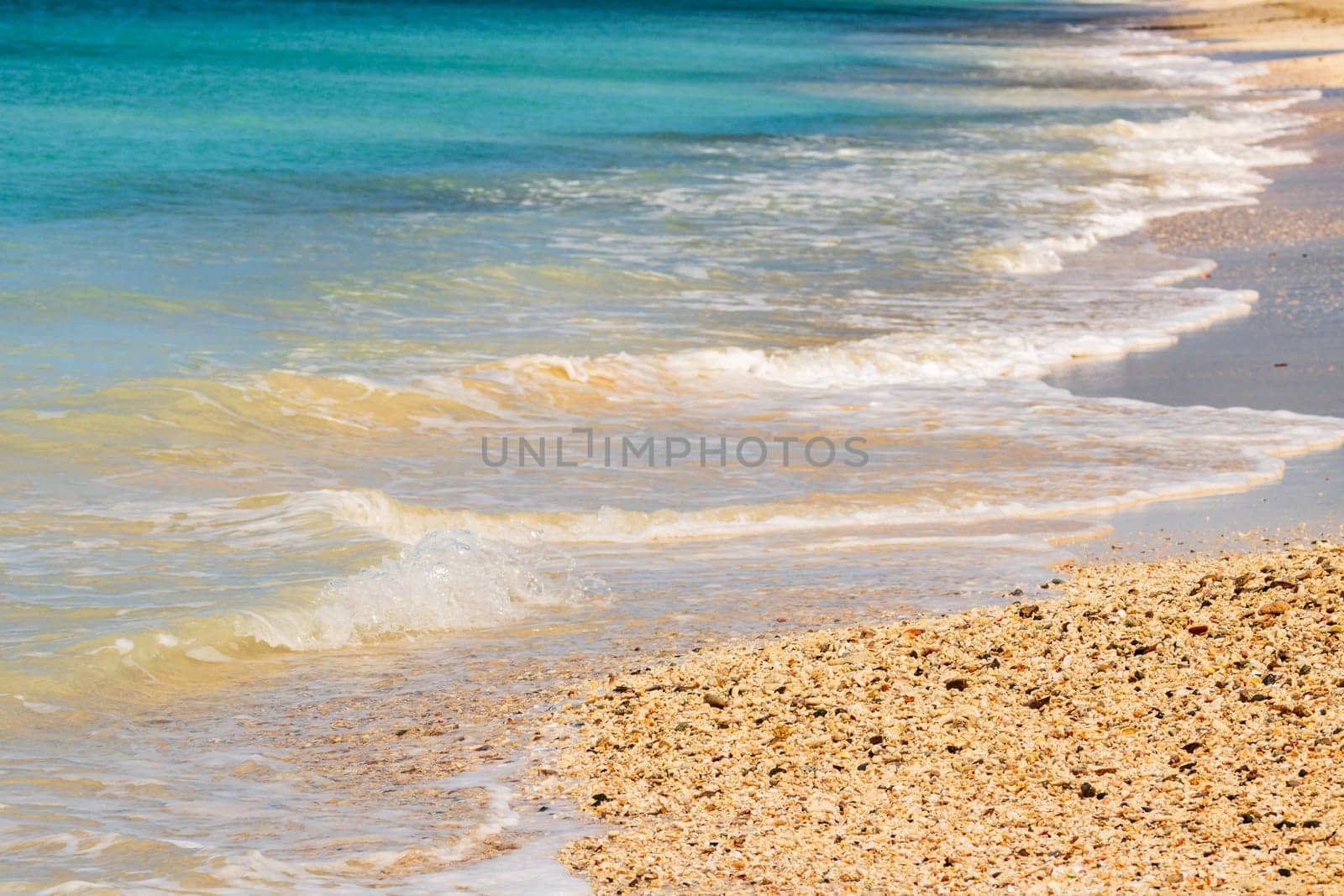 Caribbean beach with white sand, deep blue sky and turquoise water