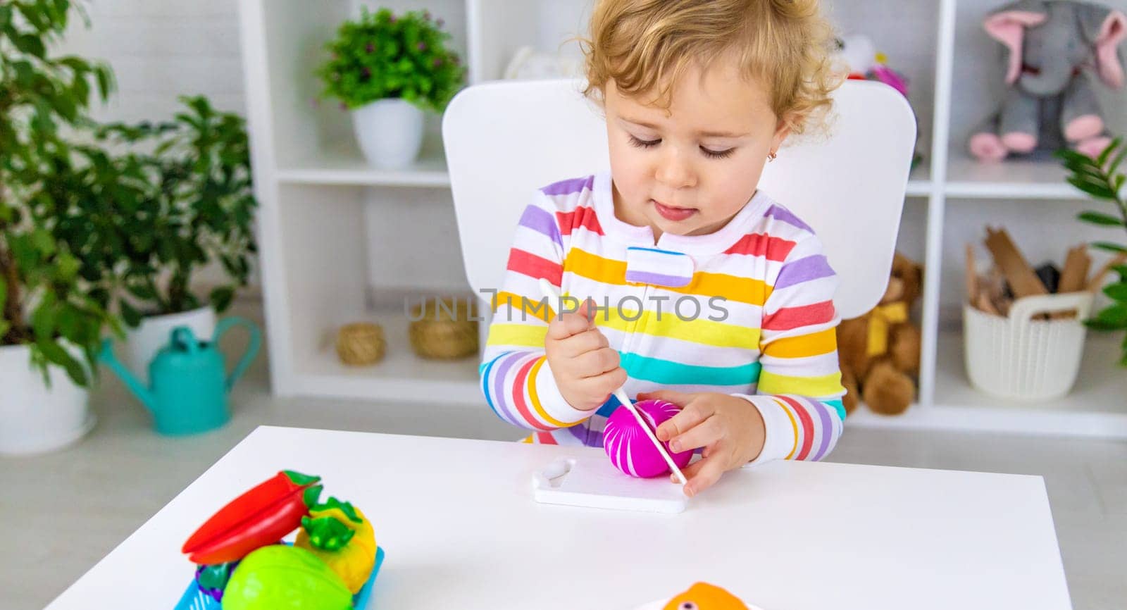 Child plays kitchen and food toys. Selective focus. Kid.