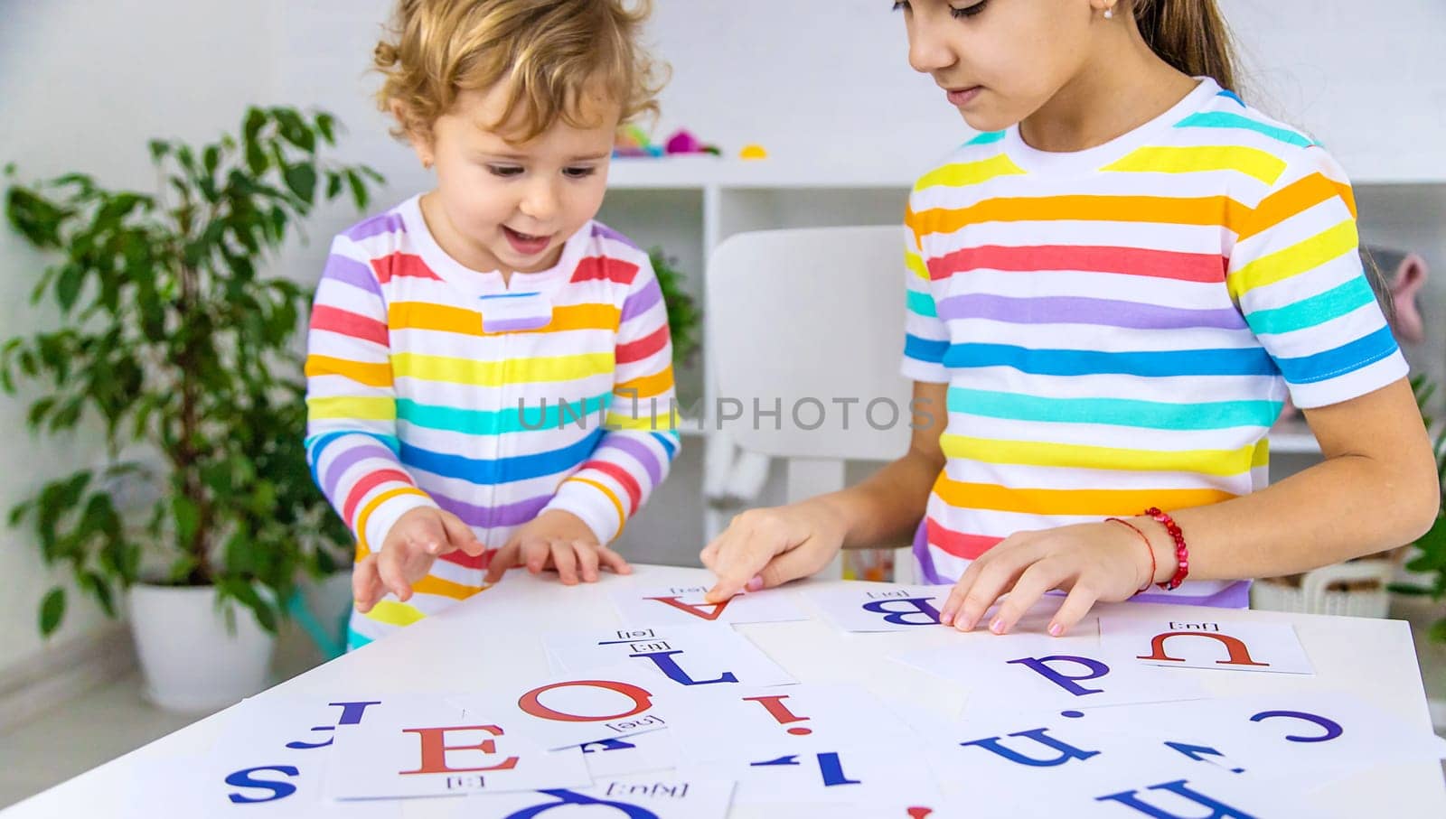 The child learns English letters. Selective focus. Kid.