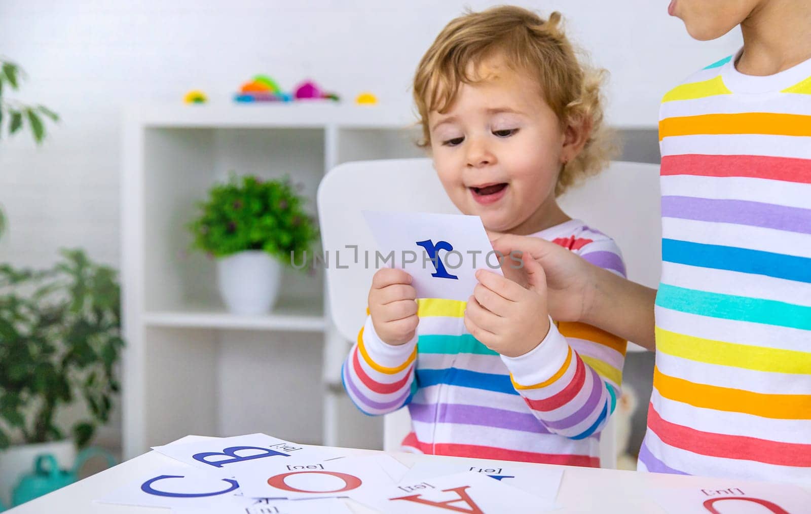 The child learns English letters. Selective focus. Kid.