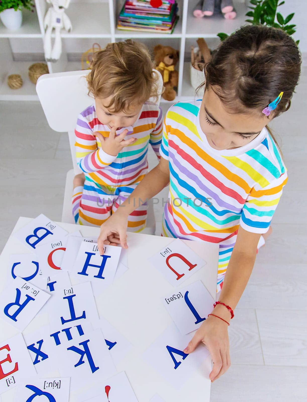 The child learns English letters. Selective focus. Kid.