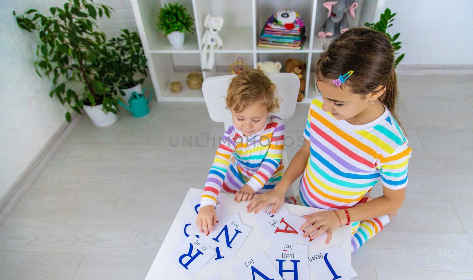 The child learns English letters. Selective focus. Kid.