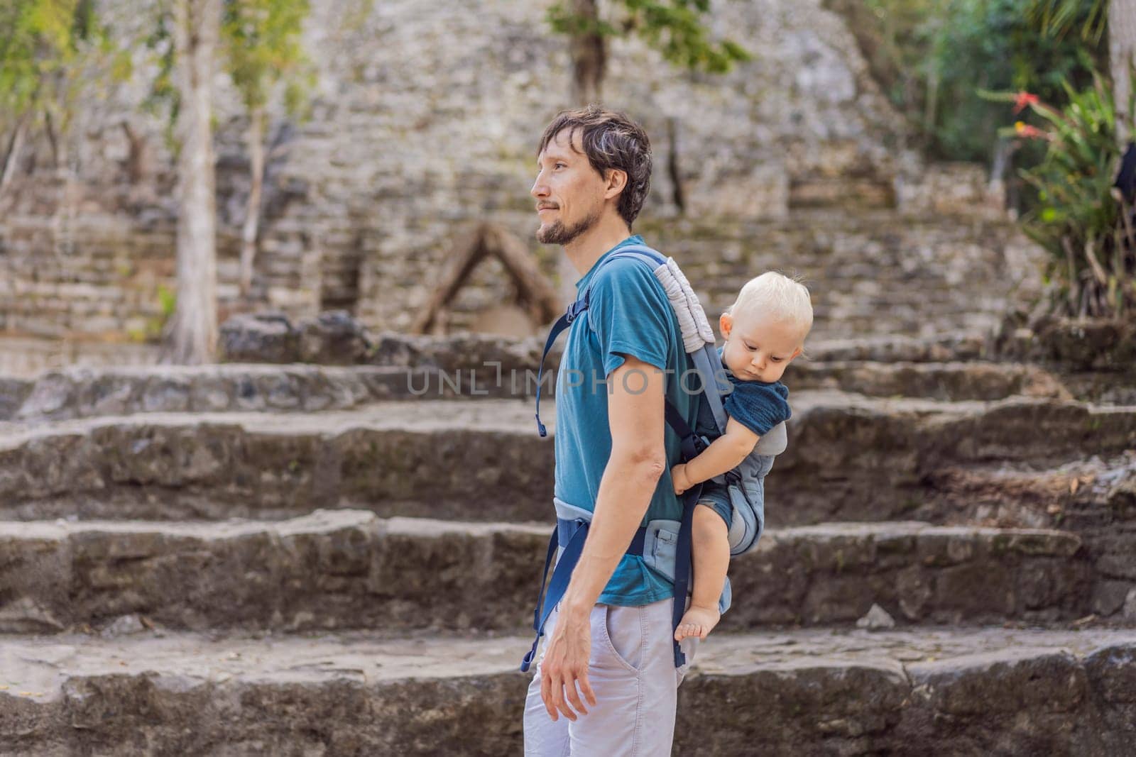 Dad and son tourists at Coba, Mexico. Ancient mayan city in Mexico. Coba is an archaeological area and a famous landmark of Yucatan Peninsula. Cloudy sky over a pyramid in Mexico.