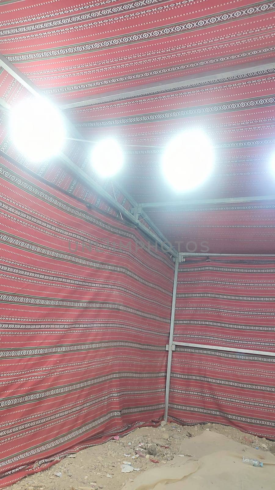 Bedouin tent, red traditional fabric, light bulbs. High quality photo