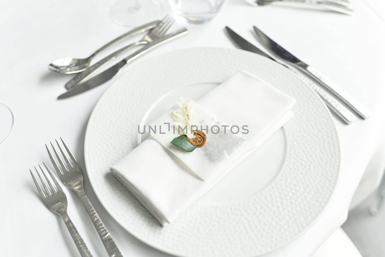 Table setting with cutlery and white napkin by Godi