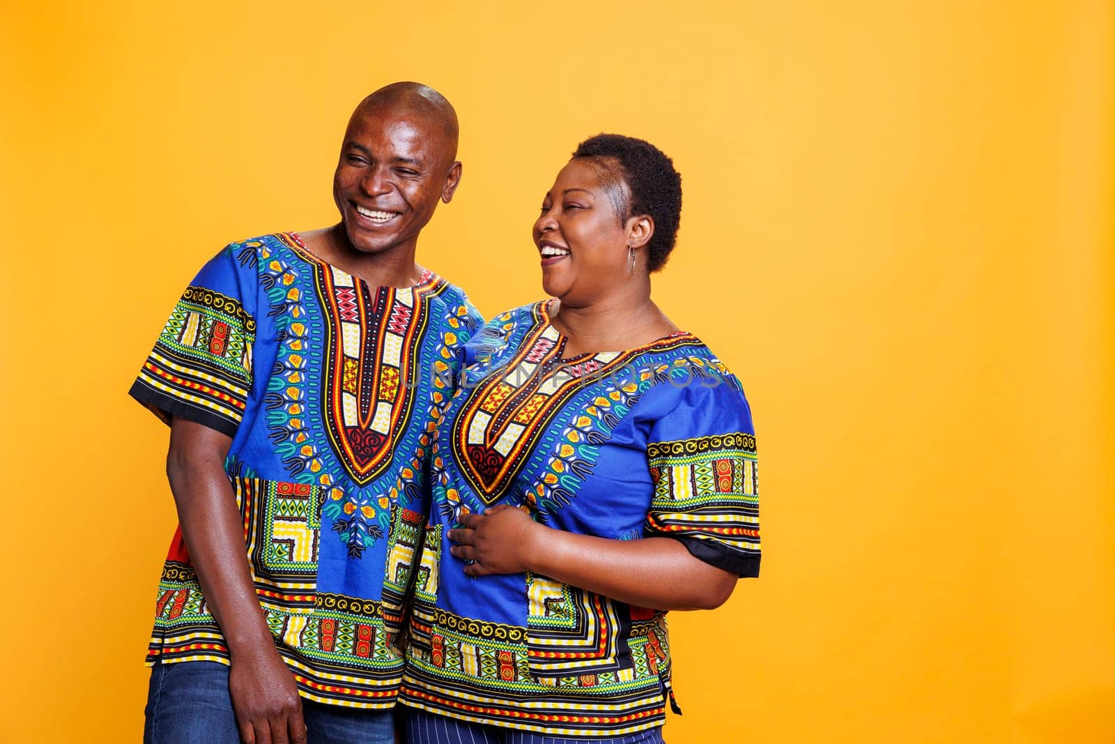 Smiling happy man and woman romantic couple laughing and looking at camera. Mid adult boyfriend and girlfriend having fun together with cheerful expression while posing for portrait