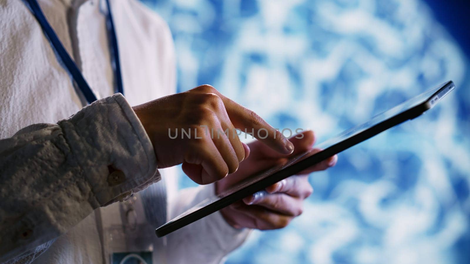 Licensed employee using tablet to maintenance artificial intelligence neural networks made up of interconnected nodes. Dilligent worker upgrades AI system processing information, close up