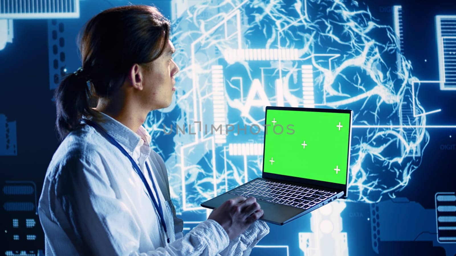 Engineer using mockup laptop to implement artificial intelligence parallel processing. Qualified administrator works on green screen device, enabling AI systems to process machine learning data