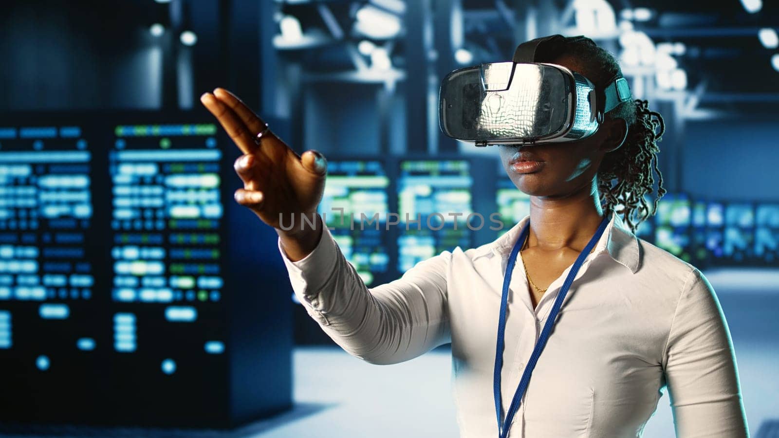 African american certified developer immersed in virtual reality at data center, doing units maintenance. Licensed technician using VR headset to optimize servers performance, checking operations