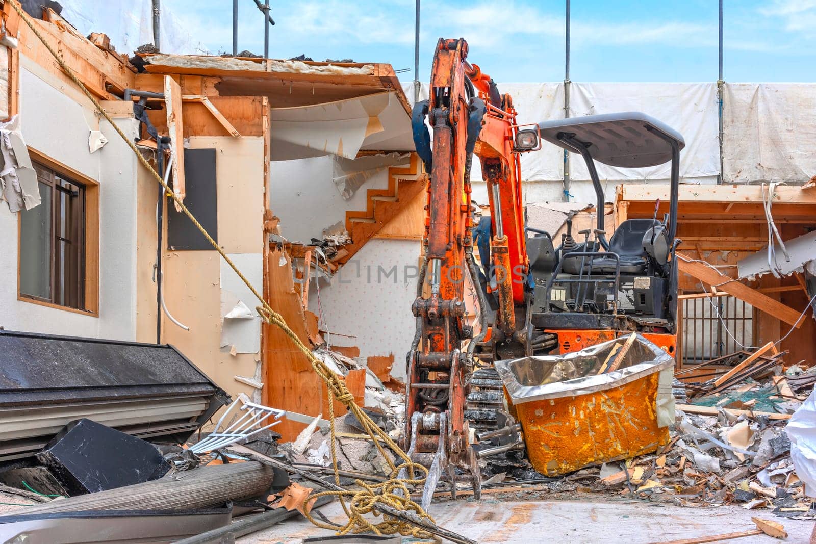 An orange backhoe loader equipped with a hydraulic excavator attachment. by kuremo