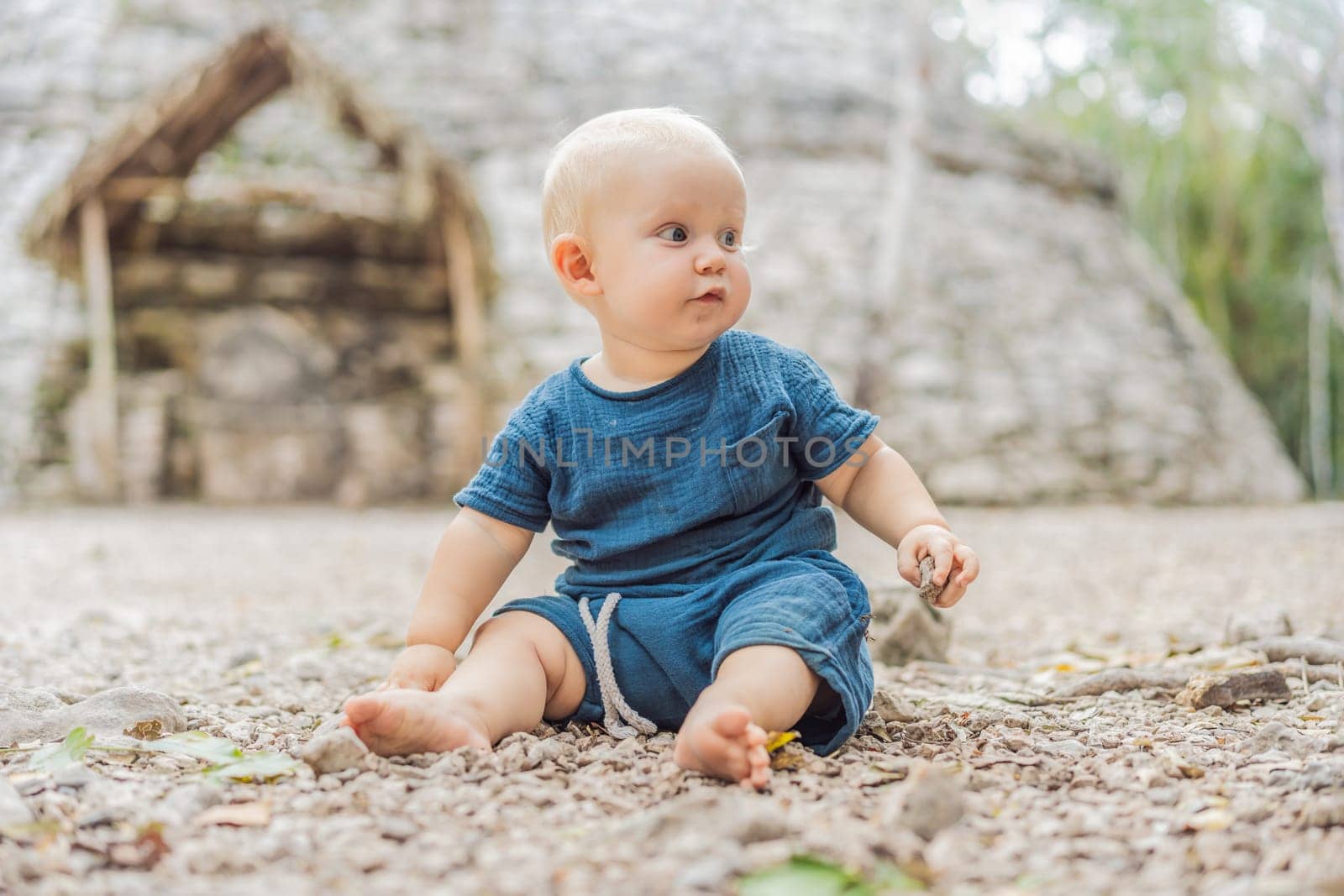 Baby tourist at Coba, Mexico. Ancient mayan city in Mexico. Coba is an archaeological area and a famous landmark of Yucatan Peninsula. Cloudy sky over a pyramid in Mexico.