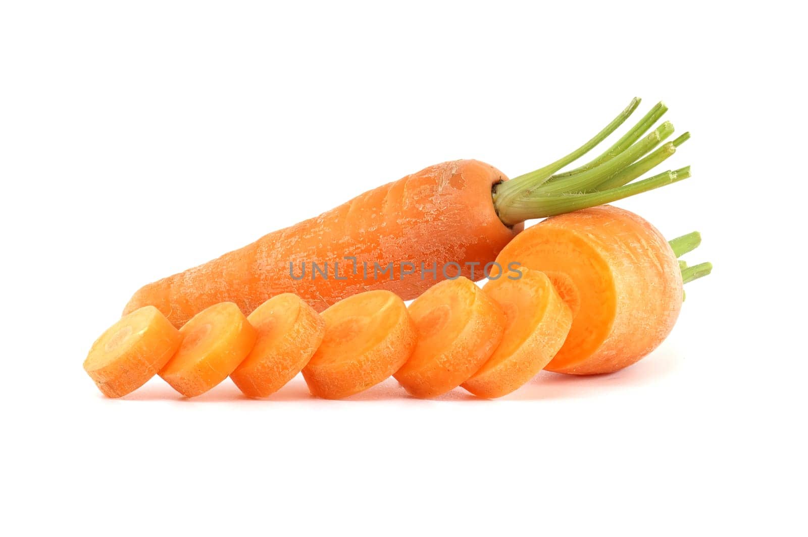 Whole carrot and its sliced pieces isolated against a white background by NetPix