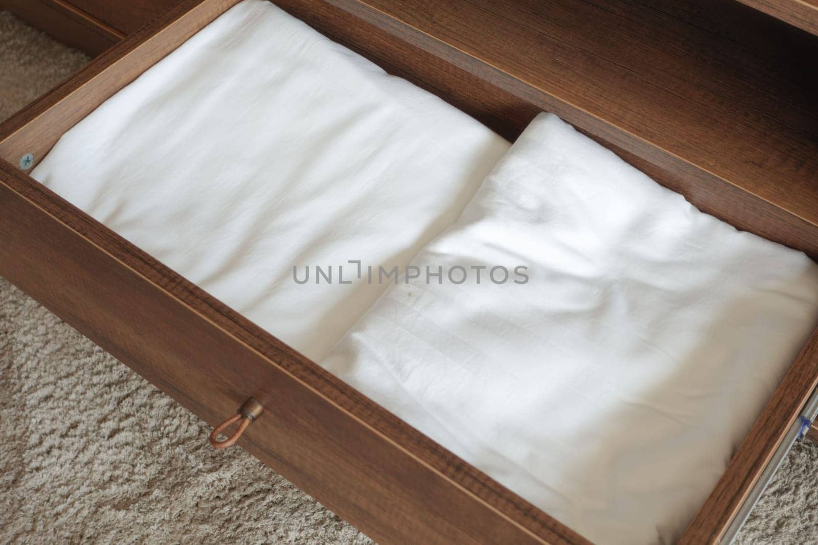 Hardwood drawer with two white linens in a varnished wood stain by towfiq007