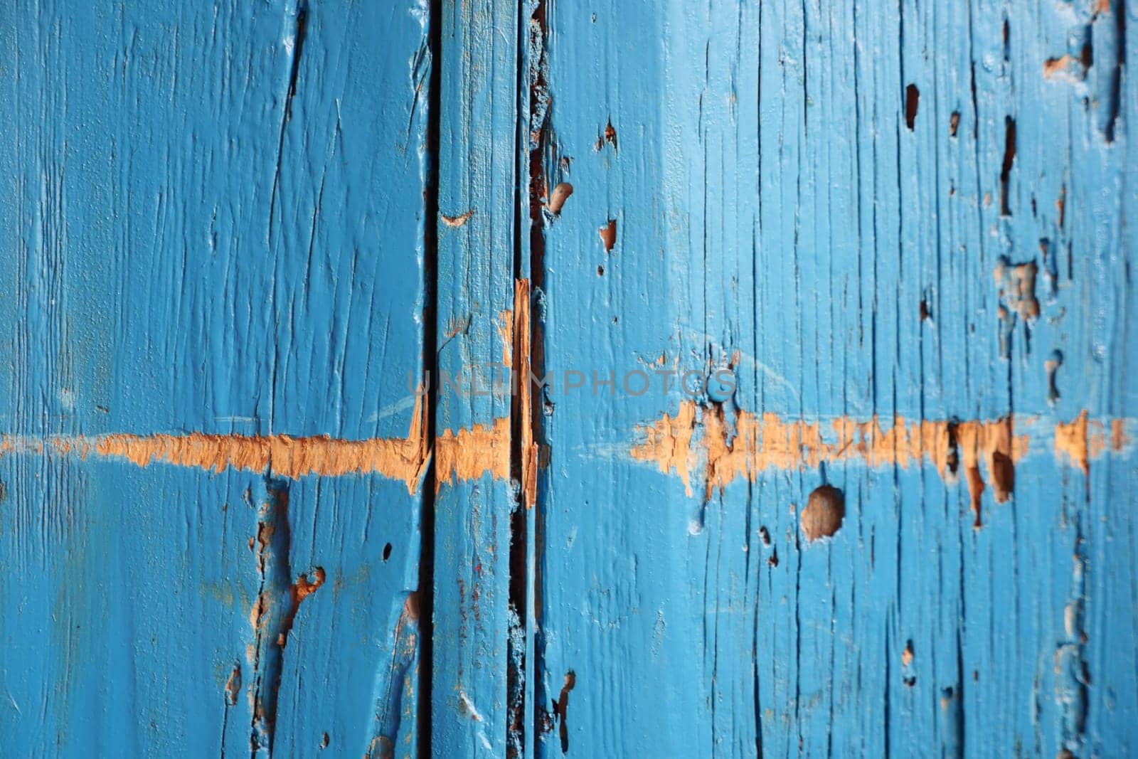 Close up of an electric blue wooden door with peeling paint by towfiq007