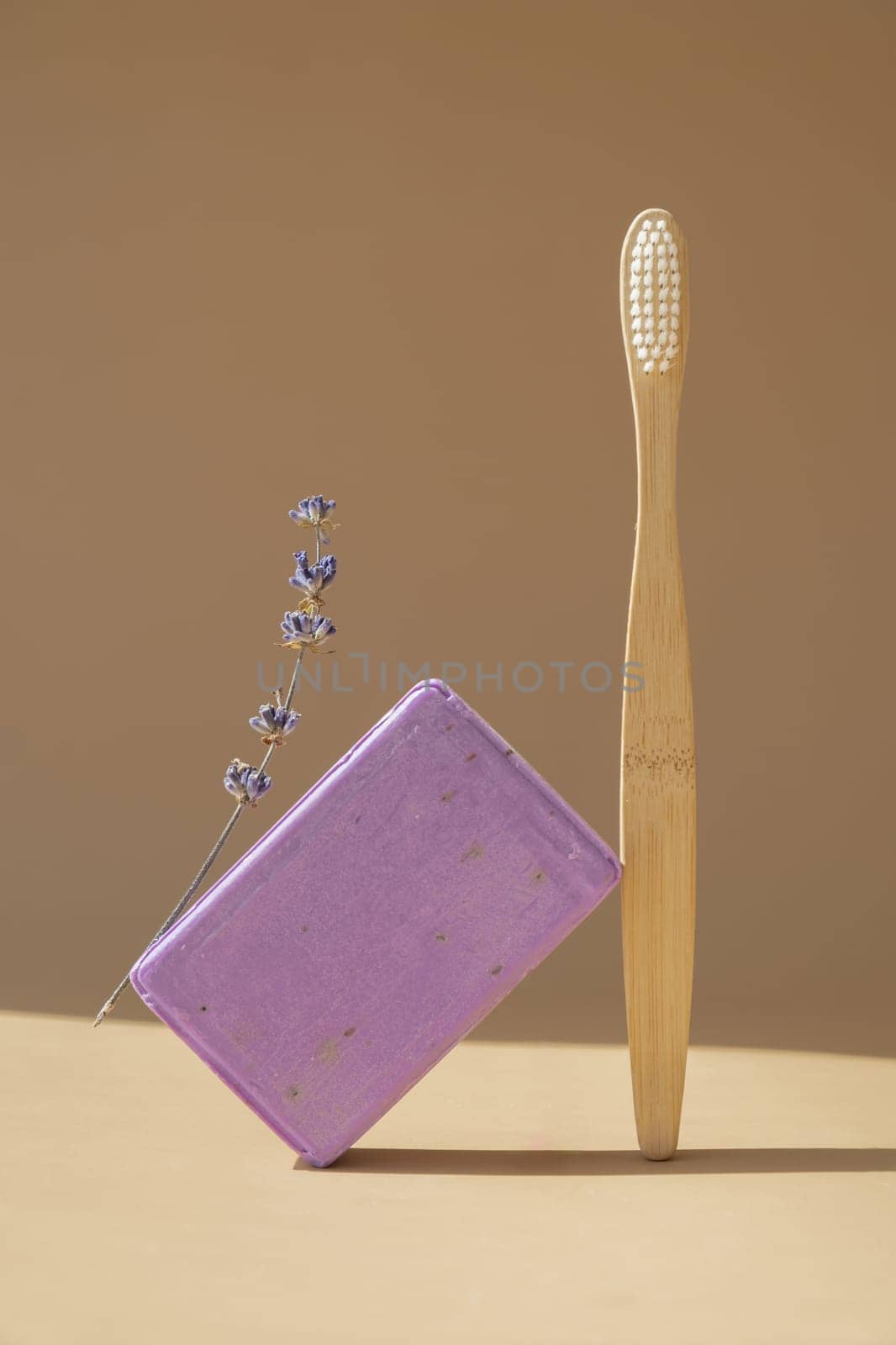 Bamboo toothbrush and Lavender soap on beige background with copy space for your text. Advertisement template mock up. Skincare homemade natural cosmetic concept. Organic dry lavender flower by anna_stasiia