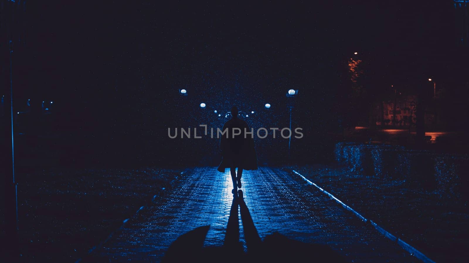 male detective in a hat and raincoat at night in a rainy city in the style of film noir