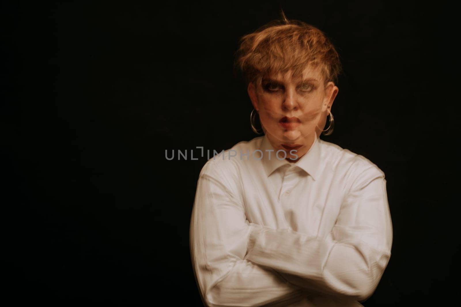 psychopath with mental disorders and insanity on a dark background. A blurry portrait of a woman in a straitjacket