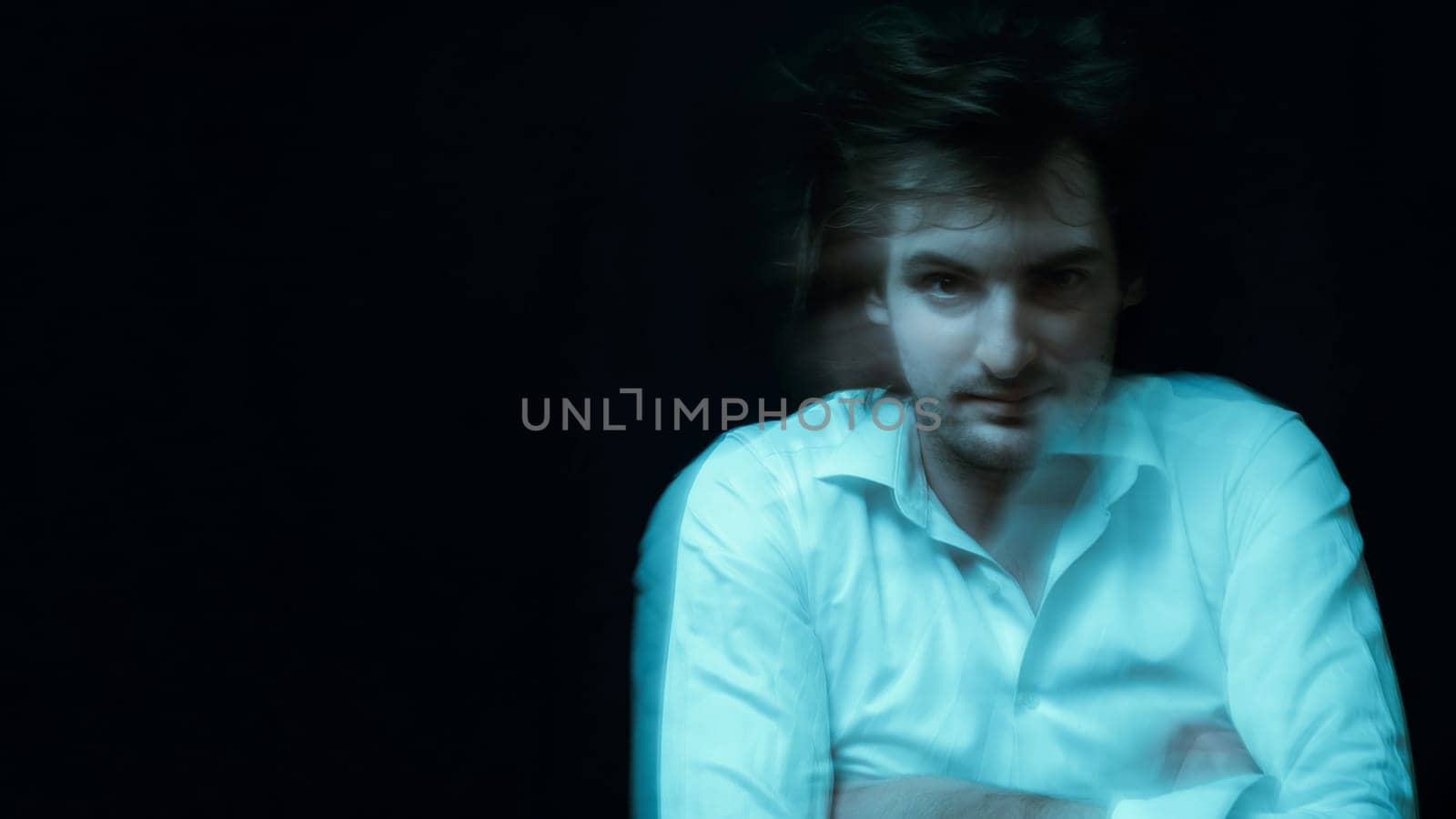 schizophrenic portrait of man with mental disorders and mental illnesses in straitjacket on dark background
