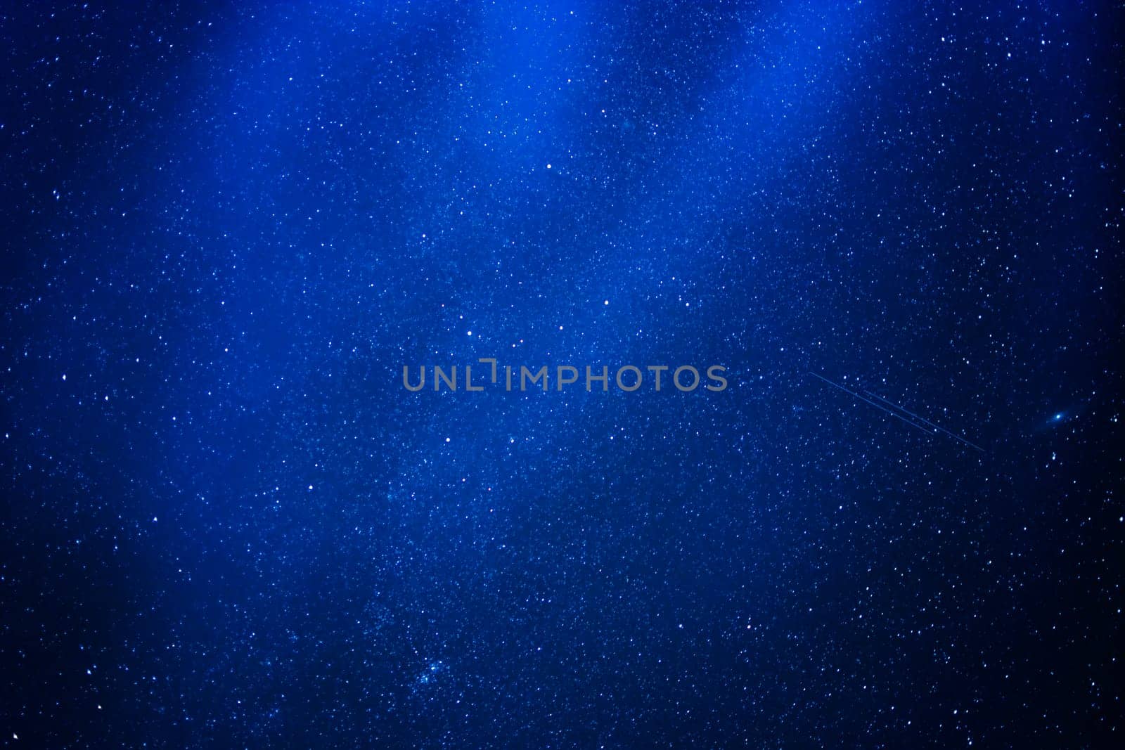 abstract blue background of stars in the night sky with the milky way