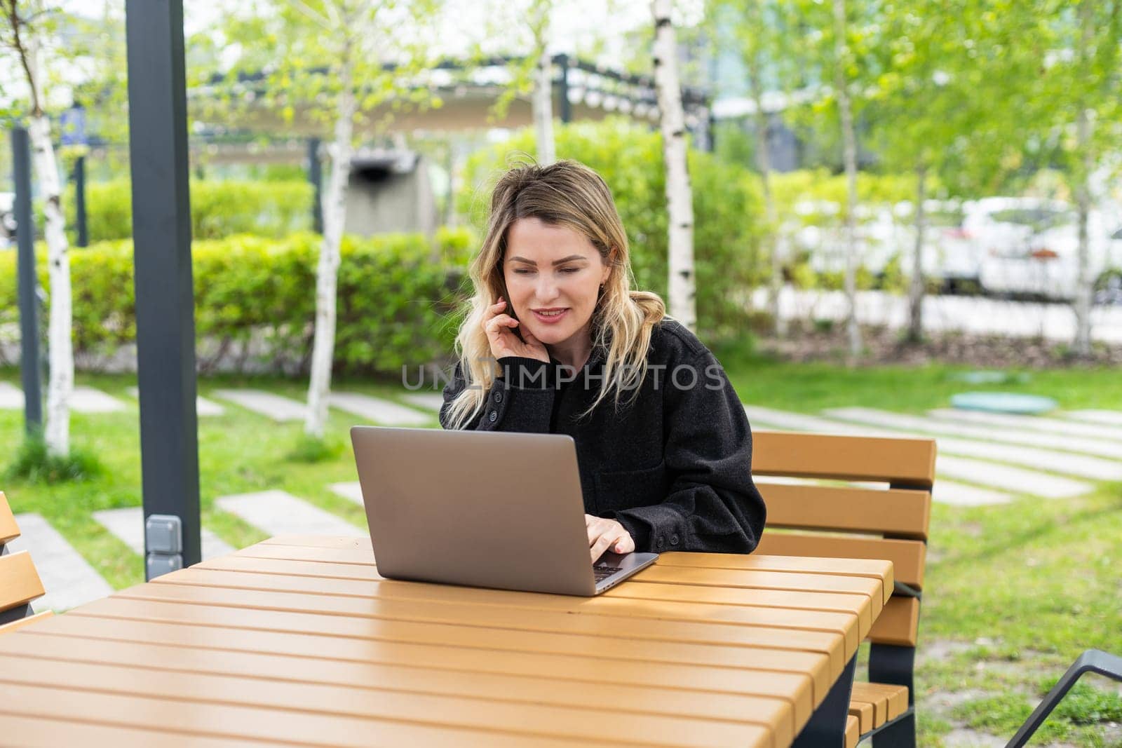 Young woman with laptop outside by Andelov13