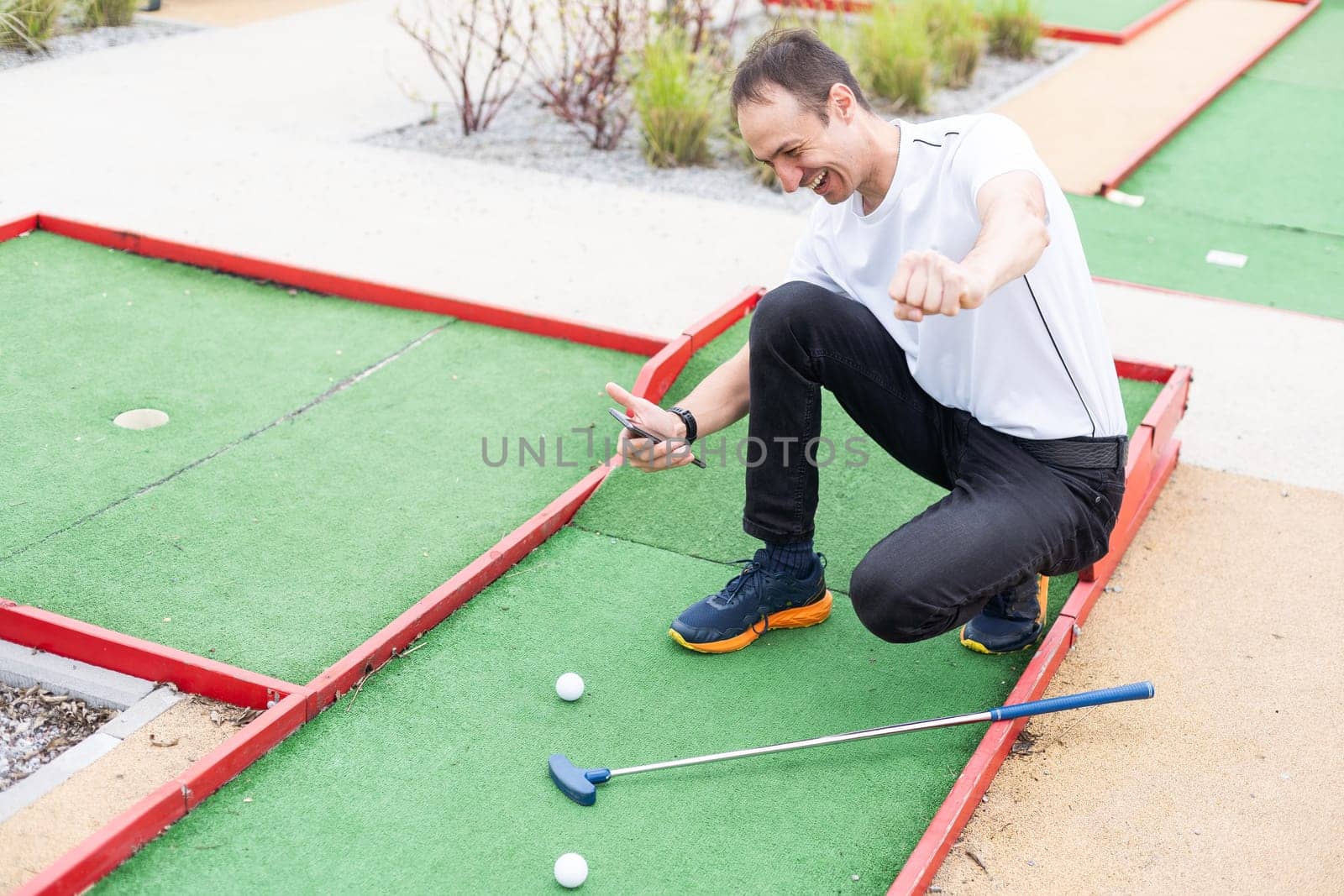 player looks at his hit on a mini golf course. High quality photo