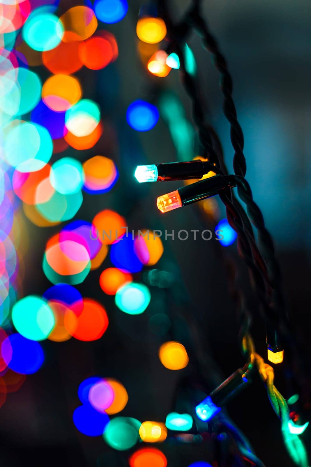 colorful Christmas lights garlands closeup with beautiful blurred backgrounds