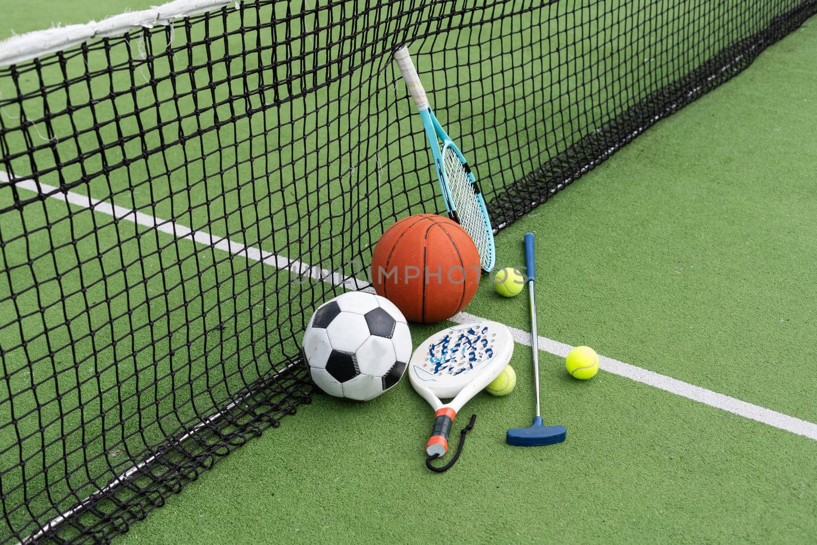 A group of sports equipment on background including tennis, basketball, and soccer on a background with copy space. High quality photo