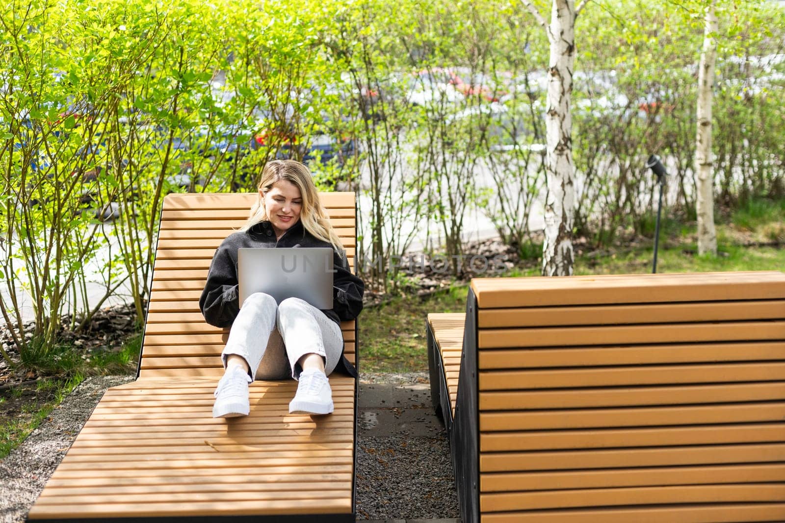 Young business woman working at laptop in the city. High quality photo