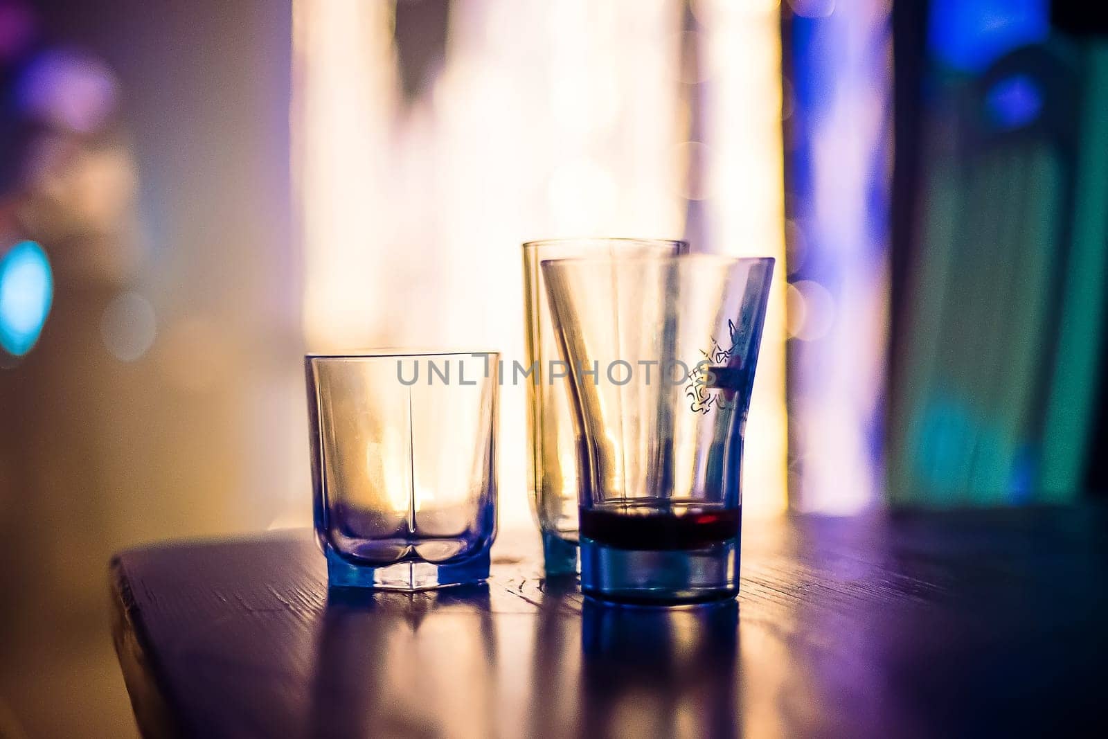empty glasses of vodka at a party in a nightclub