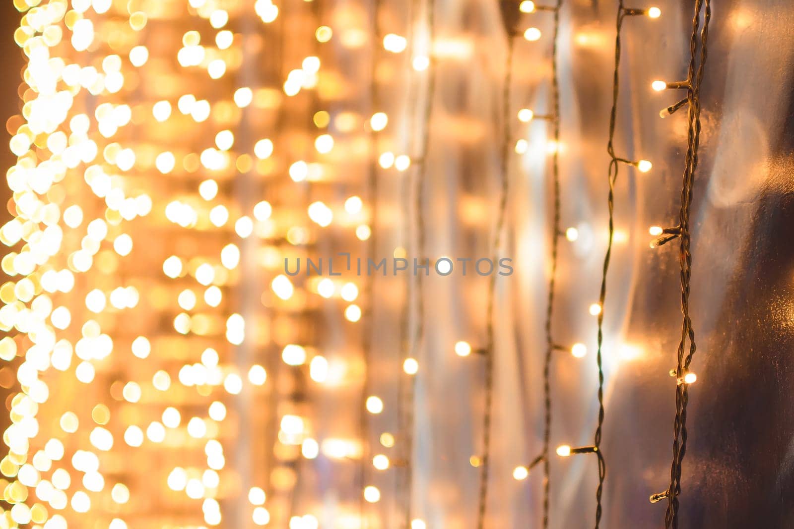 Christmas garland hanging on the wall, with beautiful Golden bokeh