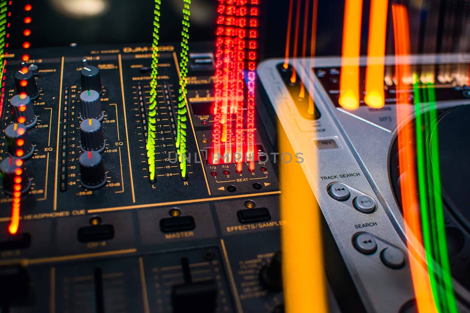 DJ mixer in night club colored closeup
