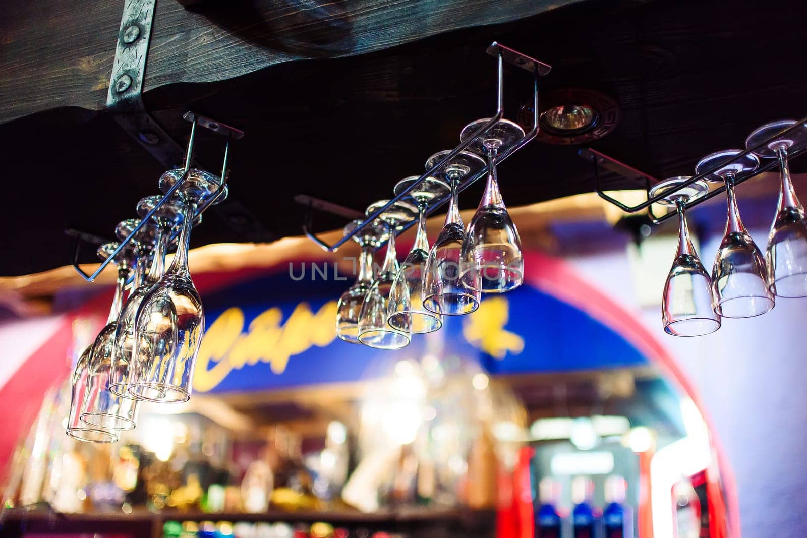 Empty glasses for wine above a bar rack