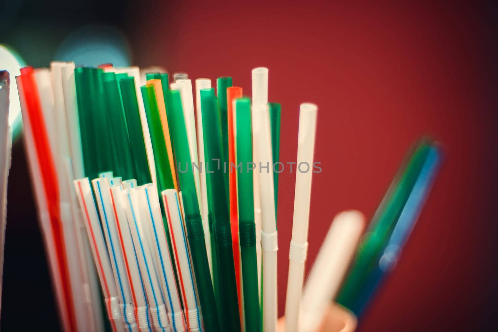 many colorful plastic straws for drinks close up