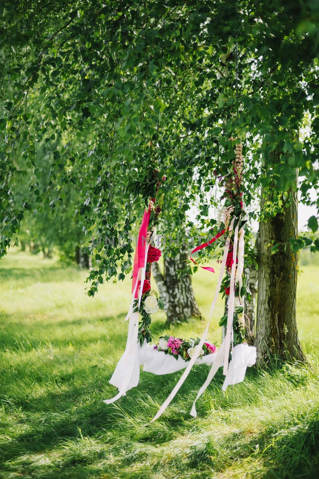 swing decorated with flowers for romance couple in love in the summer