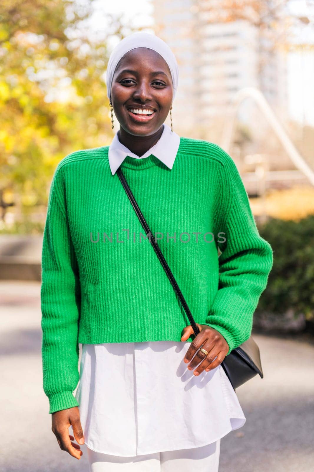 muslim black woman smiling happy looking at camera by raulmelldo