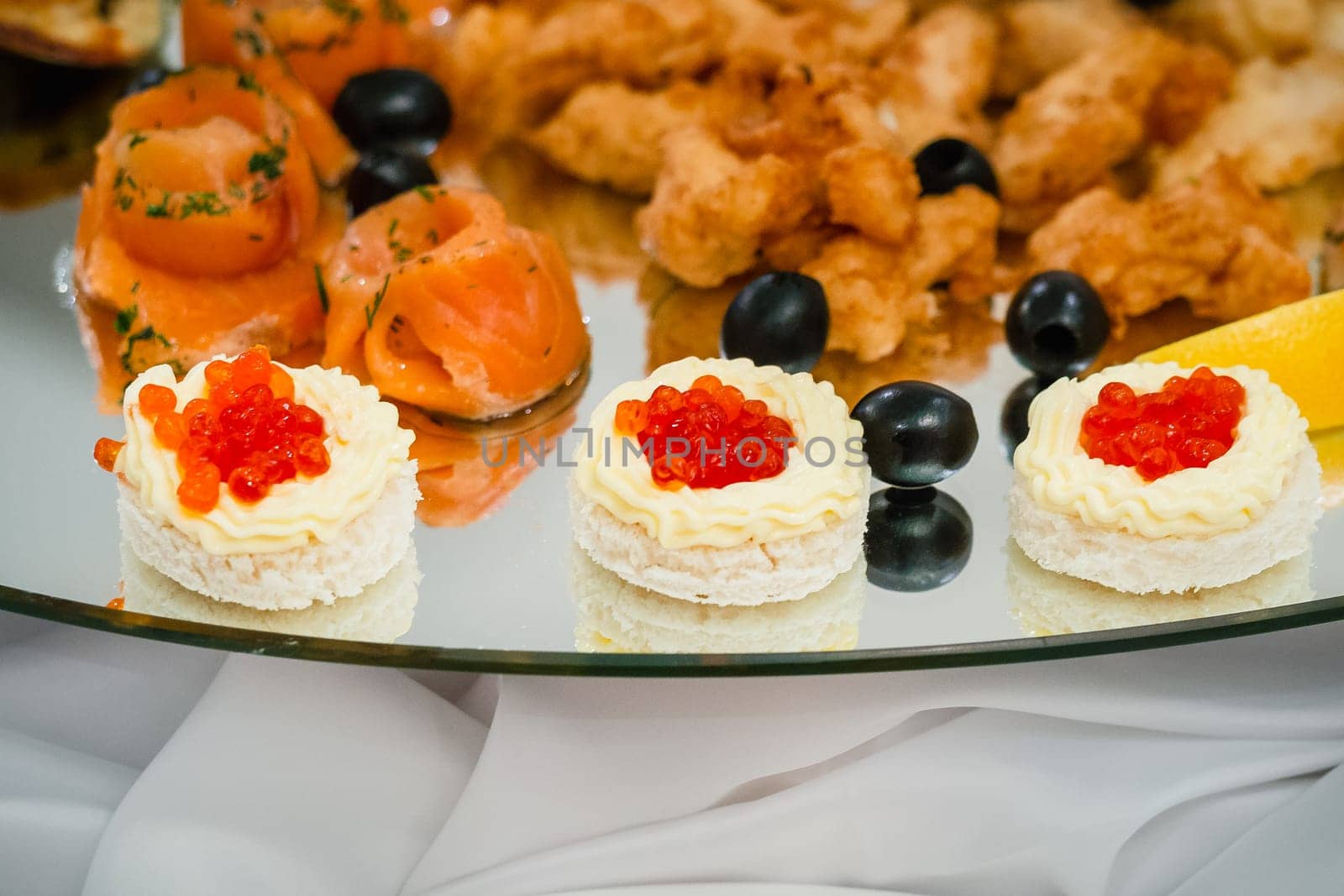 caviar fish, and pieces of red fish in the restaurant on a plate closeup
