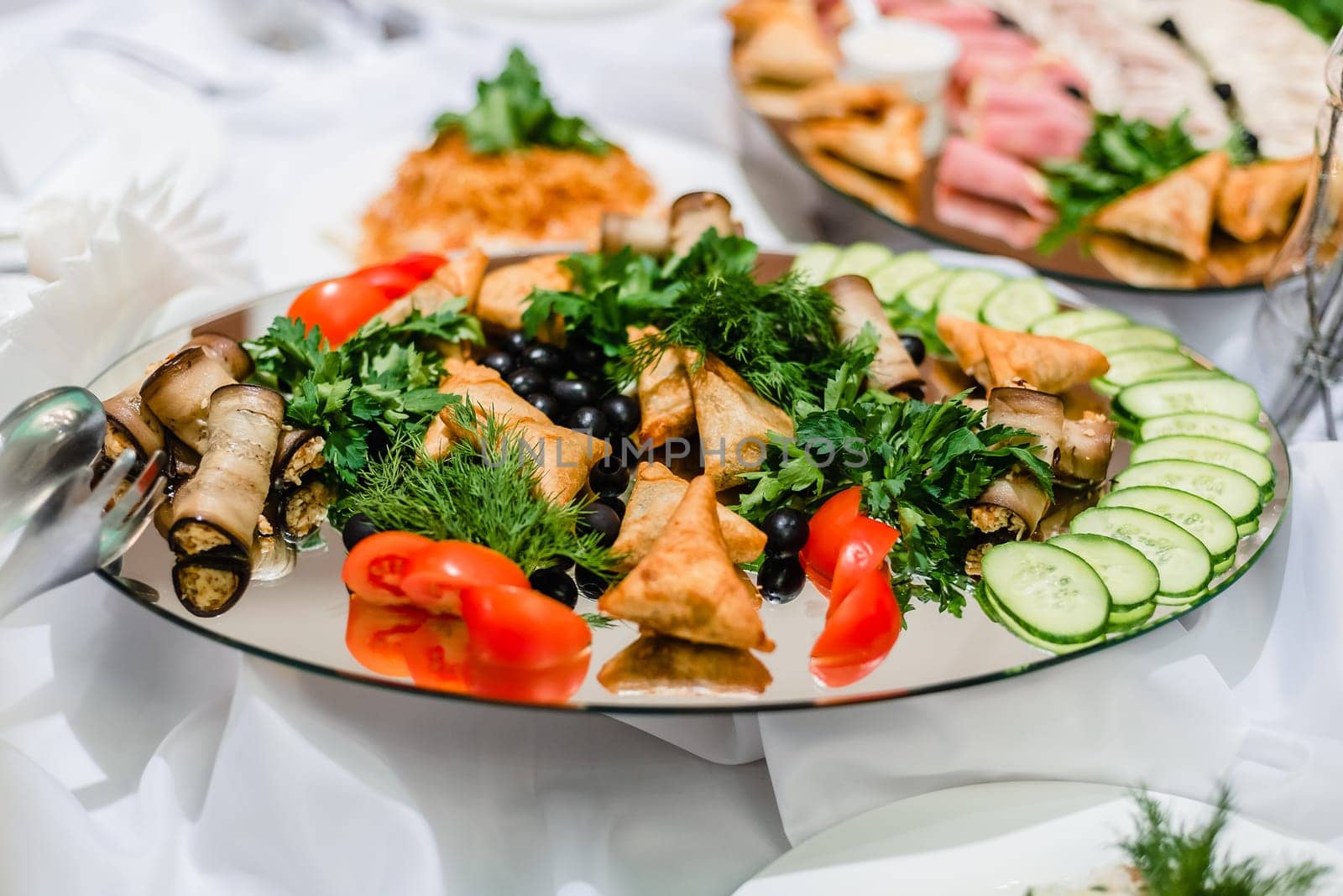 food on the plate of chopped cucumber, tomato, fresh green parsley and dill