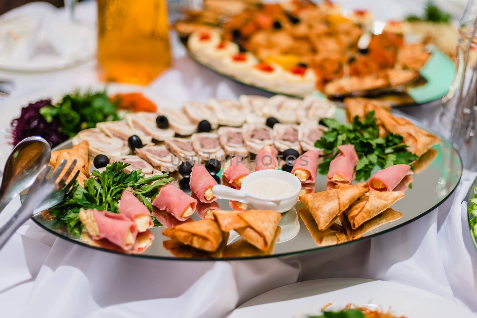 sliced meats from ready meats in the restaurant, with olives and parsley