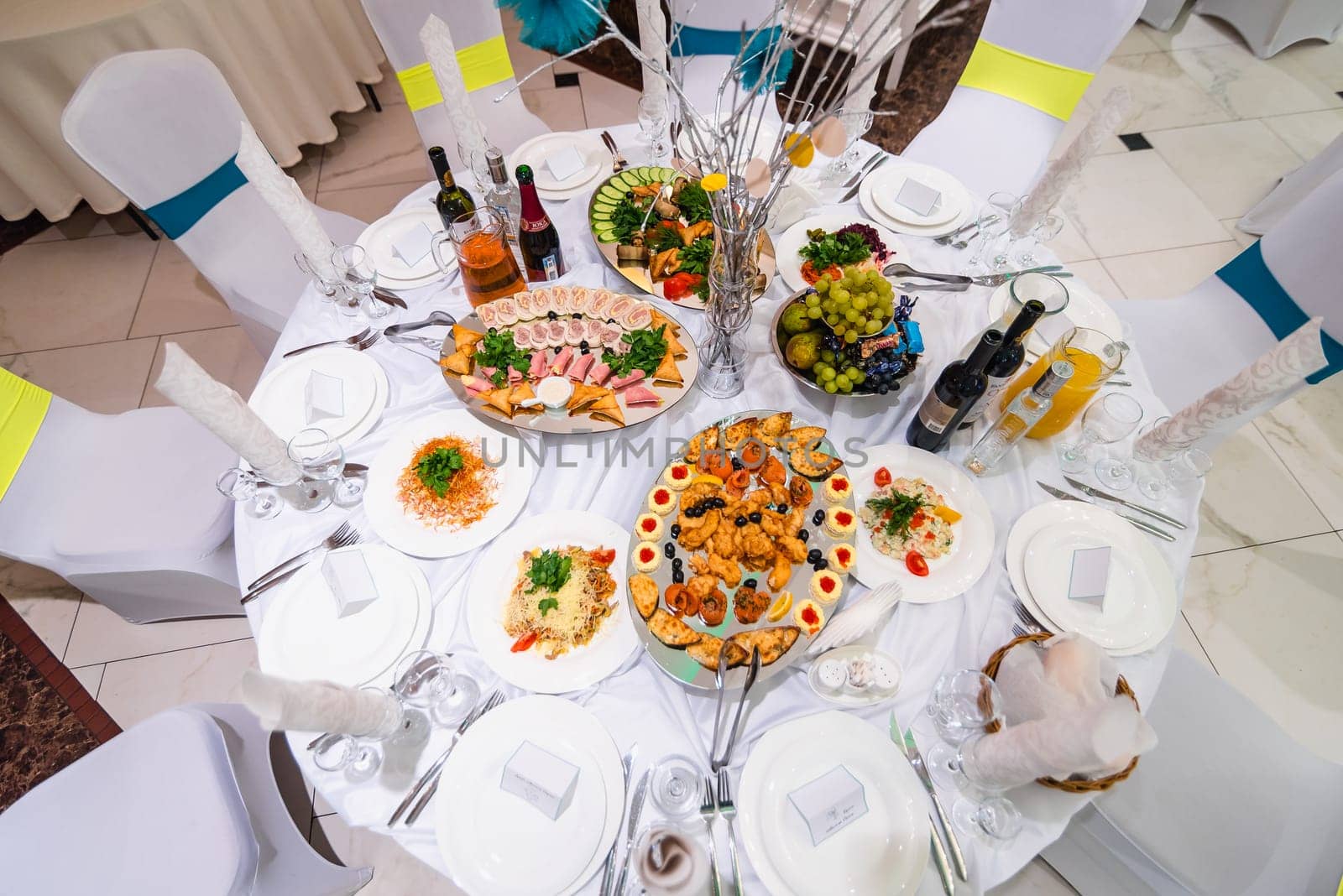 festive white table with food and drinks in the restaurant for a wedding event