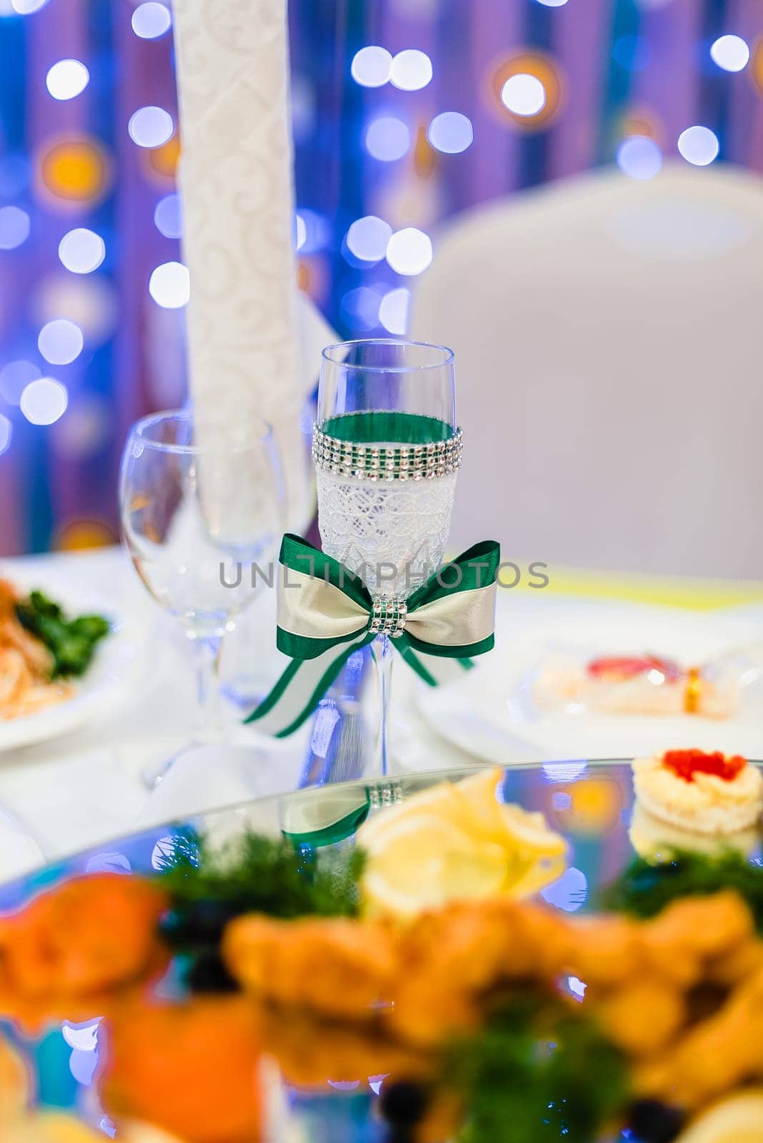 wedding decorated wine glass on the wedding table