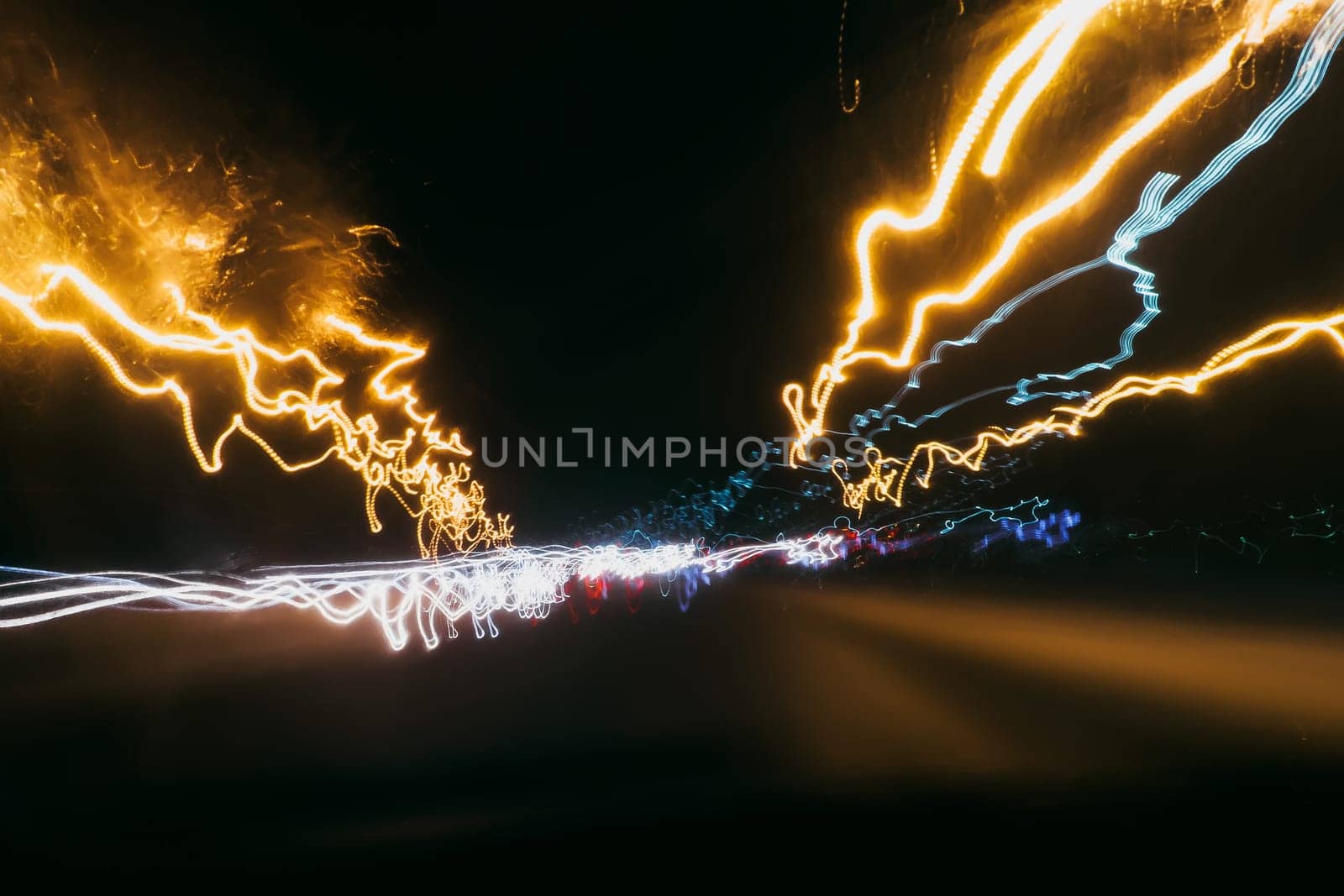 blurred abstract traces of bright night lights of cars