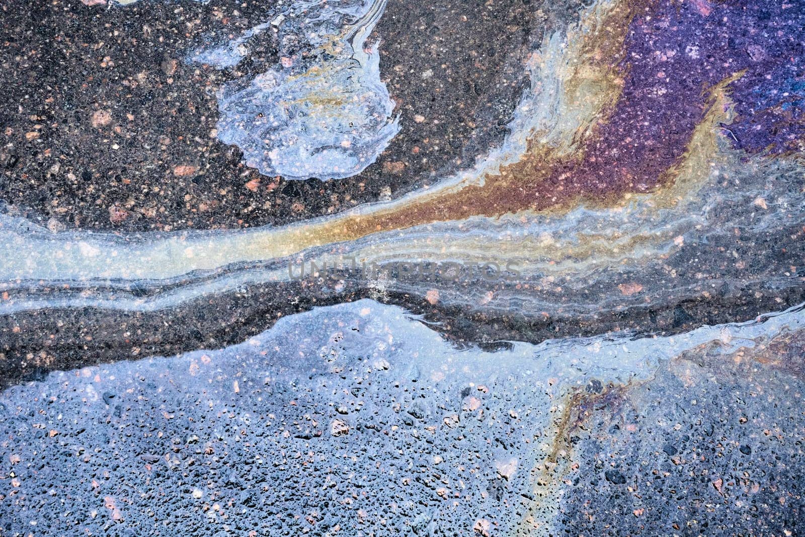 Oil Spill on Asphalt, Colorful Gasoline Fuel Stains on Asphalt Road as Texture or Background. by AliaksandrFilimonau